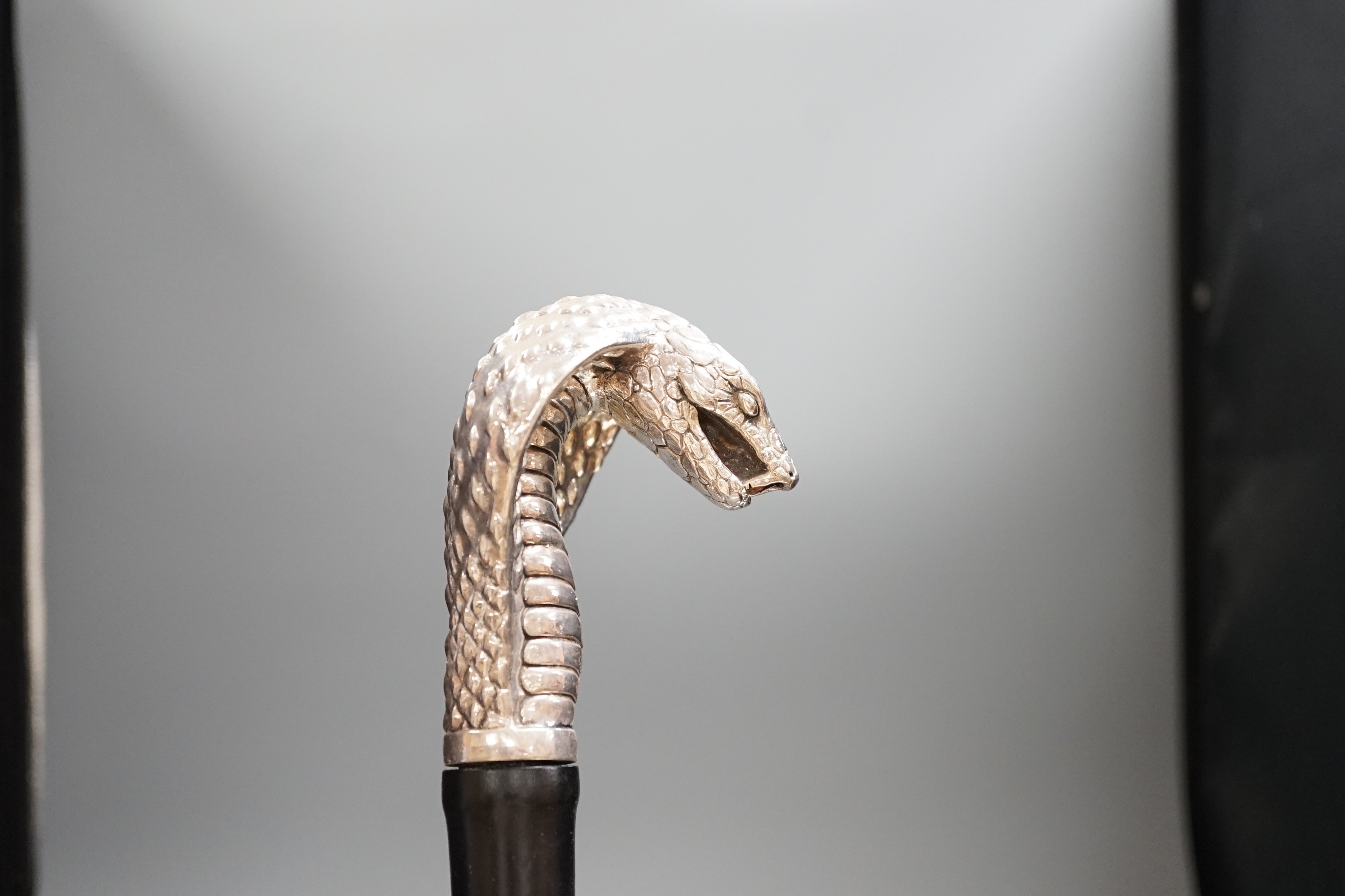 A Jeffery West umbrella with silver cobra handle,94cmslong